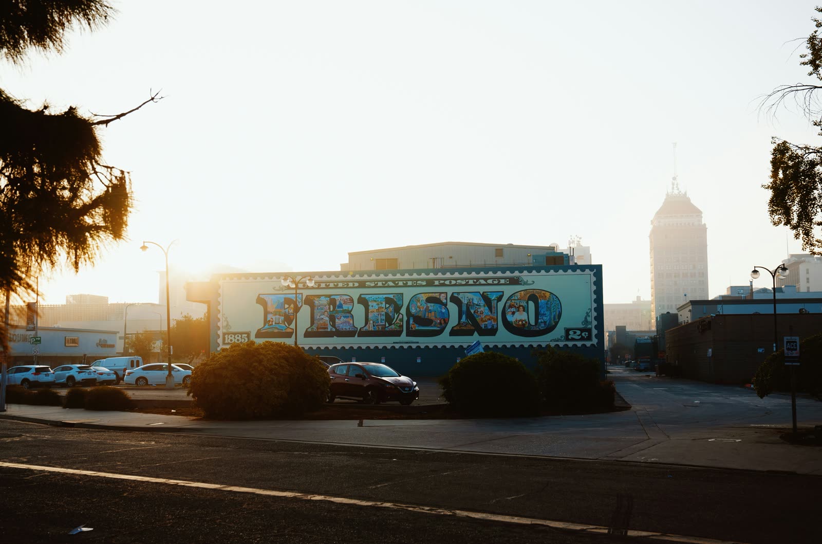 The Fresno postage stamp mural at sunrise, Pacific Southwest Building behind